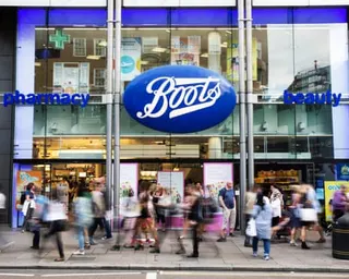 Members of the public walk past a branch of Boots the chemist in Oxford Street, London