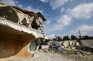 The illegal building in Sungai Tekali being demolished by the authorities. They previously housed Rohingya refugees, who claimed the landowner had offered them the units for rent. NSTP/NABILA ADLINA AZAHARI