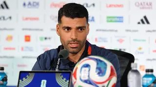 Mehdi Taremi speaks into a microphone while conducting a press conference