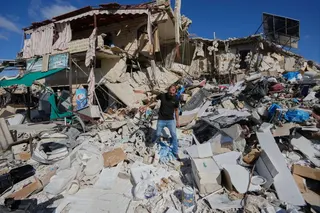A man who returns to his village following the announcement of an initial ceasefire agreement between the United States and Iran, inspects his destroyed house in Tibnin village, south Lebanon, on Monday. Photo: AP