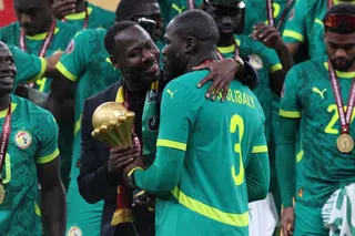 Senegal coach Pape Thiaw and Kalidou Koulibaly celebrate with the trophy after the Africa Cup of Nations Final in Morocco in January