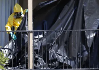 A worker wearing a hazardous material suit puts up a tarpaulin at the apartment unit where Thomas Eric Duncan, a Liberian citizen diagnosed with the Ebola virus, was staying in Dallas, Texas in this file photo take on October 3, 2014. — Reuters pic