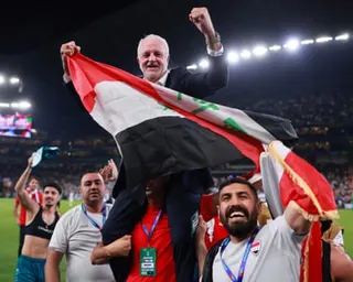 Graham Arnold celebrates after Iraq beat Bolivia in their World Cup playoff in Mexico
