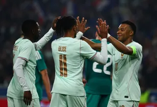 Michael Olise celebrates scoring their first goal against Northern Ireland with Ousmane Dembele and Kylian Mbappe