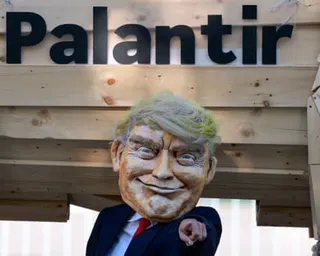 A person wearing a mask representing the US president, Donald Trump, gestures next to a 'Trojan horse' as activists demonstrate in front of the chancellery against the planned nationwide use of Palantir software, in Berlin, Germany