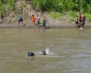 A teenage girl swims across a crocodile-filled river to reach a school