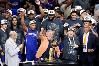 New York Knicks owner James Dolan (center) celebrates with the Larry O'Brien trophy on Saturday night in San Antonio.