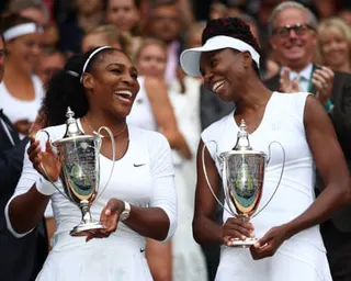 Venus Williams, right, and sister Serena holding their trophies at the All England Club after winning their sixth Wimbledon doubles title together in 2016.