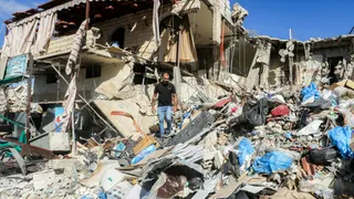 A man inspects his destroyed house upon his return to his home village of Tibnin in southern Lebanon on June 15, 2026