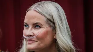 Getty Images A headshot of Mette-Marit wearing a breathing tube connected to an oxygen device