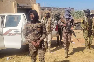 This handout picture released by the Sudanese Rapid Support Forces (RSF) on October 30, 2025, shows RSF members reportedly detaining a fighter known as Abu Lulu (L) in El-Fasher, in war-torn Sudans western Darfur region. In a statement late on October 30, the RSF said it had detained several fighters accused of "violations that occurred during the liberation" of the city, including Lulu who appeared in multiple videos on his TikTok committing summary executions. The RSF, at war with the army si
