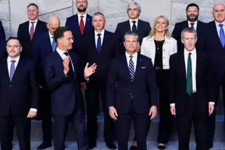EPA Defence ministers are lined up for a group picture to mark the meeting. Hegseth and Rutte are at the centre and Rutte is gesturing with his hands, while the others look unaware straight down the camera.