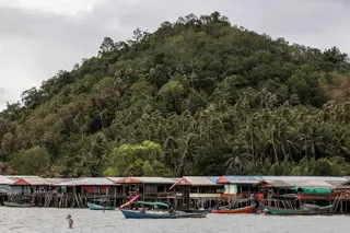 A woman walks toward her boat on Koh Phitak Island, in Chumphon province, near the site of Thailand’s proposed Southern Land Bridge project, May 17, 2026. — Reuters pic