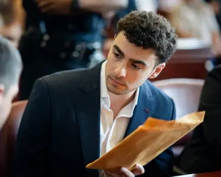 a man holds an envelope