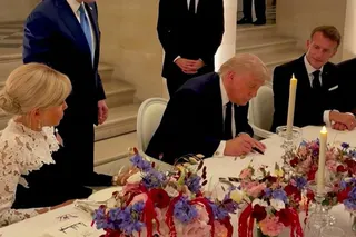 US President Donald Trump (centre) signs a memorandum of understanding with Iran in Versailles, France on June 17 as French President Emmanuel Macron (right) and his wife Brigitte Macron (left) look on. Photo: AFP and X/Scavino47