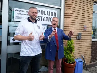 Reform UK leader Nigel Farage and party candidate Robert Kenyon outside St Aidan’s Parish Centre in Wigan, before Kenyon casts his vote in the Makerfield by-election, which was triggered by the resignation of Josh Simons.