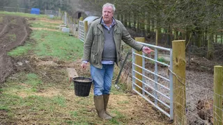 Jeremy Clarkson walks by a fence