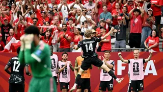 Canada's Jacob Shaffelburg celebrates with teammates their fifth goal, an own goal scored by Qatar's Mohamed Manai as Qatar's Mahmoud Abunada looks dejected.