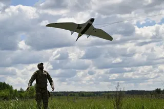 A Ukraine serviceman launches an UAV for a patrol flight along the Ukraine-Belarus border on June 1. Photo: TNS