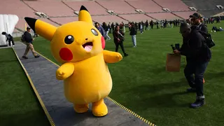 A Pikachu character walks across the field after posing for pictures with fans during the in-person Pokemon GO Tour: Kalos Los Angeles 2026 event at the Rose Bowl Stadium in Pasadena, California on February 20, 2026. Pokemon fans around the world continue to engage with the media franchise in various formats including video games, trading cards, animated series, and movies ahead of the 30th anniversary of Pokémon next week. (Photo by Patrick T. Fallon / AFP via Getty Images)