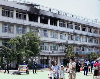Parents take their children back from Takinogawa Dai-san Elementary School on Friday. Photo: Jiji Press/AFP