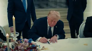 This screenshot taken from a video released by the White House on June 18, 2026 shows US President Donald Trump  signing a copy of the US-Iran agreement at the Palace of Versailles in France