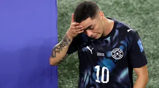 Miguel Almiron walks off the pitch holding his head after being sent off