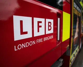 Close-up of a London Fire Brigade logo on the red side of a fire engine