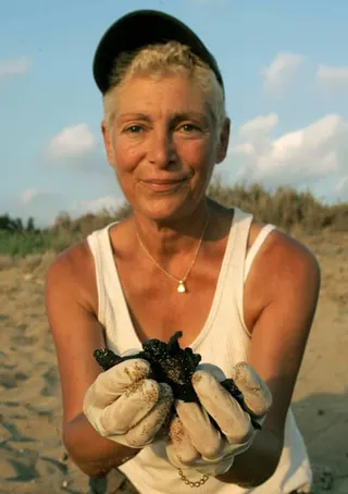 Mona Khalil shows a newborn marine turtle in 2004 near her home in Lebanon