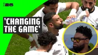 Mohamed Salah drinking from bottle of water and Micah Richards in studio