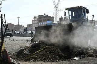 A bulldozer breaks down a barricade at a blockade zone in the city of El Alto on Saturday.