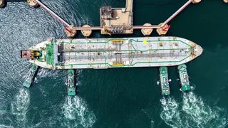 拖船將一艘原油油輪推至中國山東省青島市一處承接原油進口業務的碼頭就位。(美聯社)