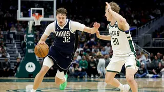 Dallas Mavericks forward Cooper Flagg drives against Milwaukee Bucks guard AJ Green during a basketball game