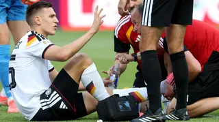 Germany defender Nico Schlotterbeck receives treatment during his side's win against Ivory Coast