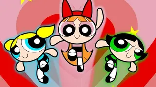 The Powerpuff Girls Blossom, Bubbles and Buttercup leaping in front of a red and pink heart