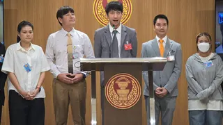 Juraluk Kunaruk (first from right), standing before the Thai parliament as MP Nitikorn Bunyakulcharoen (centre) addresses lawmakers on the spate of scams around BTS concert tickets