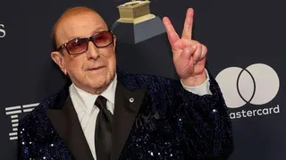 Clive Davis at the Grammys, wearing a black sequinned suit jacket.