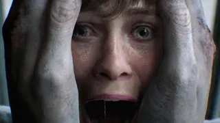 An image from Hideo Kojima's upcoming game OD showing a female with her mouth open in a scream as two large hand-looking shapes clasp her face