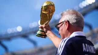 A Scotland supporter raises a replica FIFA World Cup Trophy in the stands prior to during the Group C match against Morocco