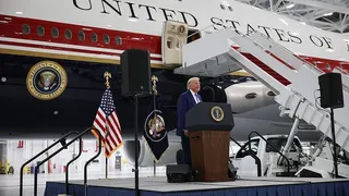 Trump in front of his Qatar-donated plane