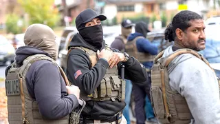 Federal law enforcement officers with ICE detaining people during a traffic stop in Washington