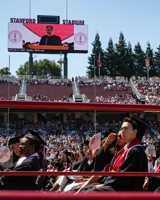 Students watch an address by Google CEO Sundar Pichai who is an alum
