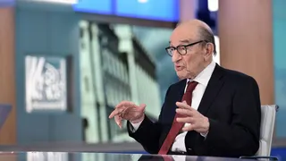 Alan Greenspan giving an interview in 2018. He is sitting on the set of a television programme and is explaining a point to an unseen interviewer