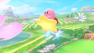 Kirby soars high over a colorful landscape on the star machine in Kirby Air Riders