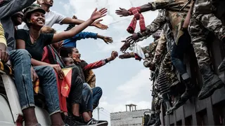TPLF supports on a bus reach out to touch hands with Tigray soldiers in Mekelle, Tigray - 2021