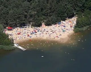 Aerial view of the lake with a sandy area leading into the water