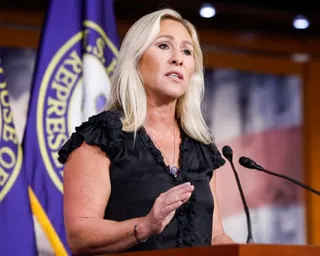a woman speaks into a microphone