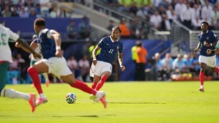 Action photo showing France's Michael Olise attempting a pass to team-mate Kylian Mbappe during the France v Senegal World Cup match on 16 June 2026