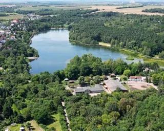 Aerial view of the lake and lush greenery surrounding it
