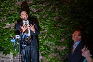 Zohran Mamdani speaks into microphones